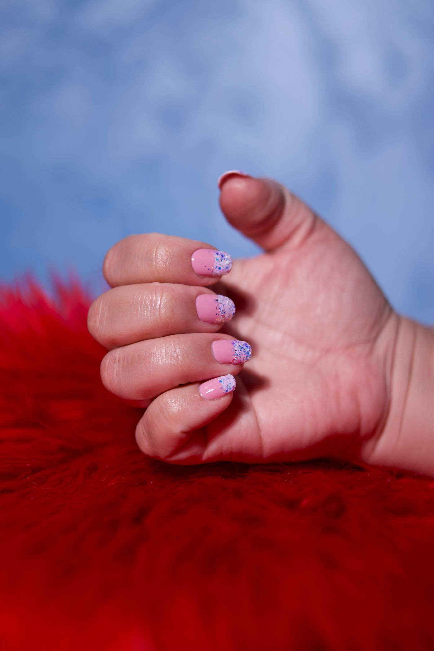 Pink glitter manicure close-up